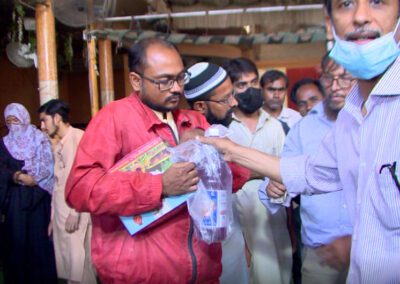 A poor man receiving a food package.